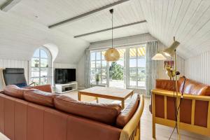 a living room with a couch and a table at 84363-Knebel-Apollovej-108 in Ørby