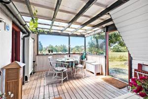 a patio with a table and chairs on a deck at 8008-Knebel-Sletterhagevej-2 in Knebel