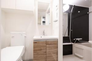 a small bathroom with a sink and a toilet at Haven Shibaura in Wada