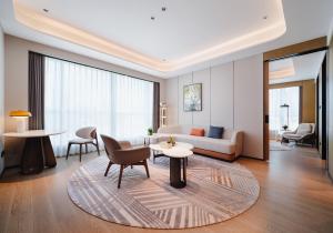 a living room with a couch and a table at Novotel Xiamen Downtown in Xiamen +36 photos