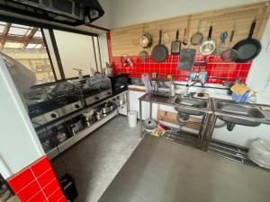 a kitchen with red tiles and a red tiled wall at みなと館 華 in Sukumo