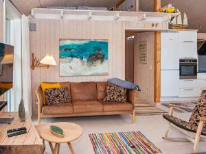 a living room with a couch and a table at 6 person holiday home in Glesborg-By Traum in Bønnerup +27 photos