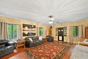 a living room with a couch and a rug at Mountain Cottage on 7 Acres in Tryon