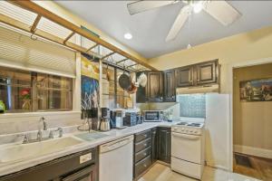 a kitchen with a white refrigerator and a sink at Mountain Cottage on 7 Acres in Tryon