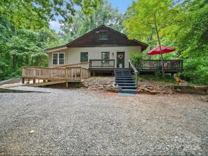 a house with a large porch and a deck at Mountain Cottage on 7 Acres in Tryon