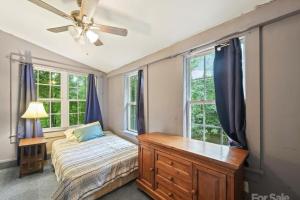 a bedroom with a bed and a ceiling fan at Mountain Cottage on 7 Acres in Tryon