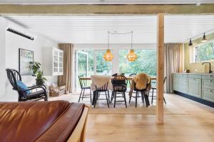 a kitchen and dining room with a table and chairs at 84127-Ebeltoft-Magevej-19 in Ebeltoft