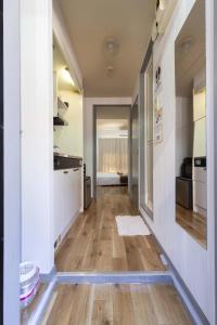 a hallway of a kitchen with a hard wood floor at Wajiro Good Place House in Fukuoka