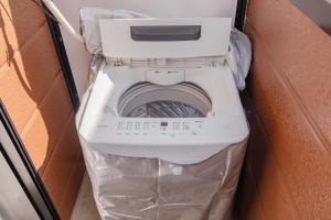 a white toilet in a box in a room at Wajiro Good Place House in Fukuoka +48 photos