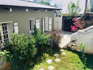a house with a garden in front of it at Maisonette de Charme à Terre Sainte in Saint-Pierre +4 photos