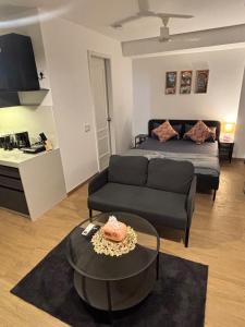 una sala de estar con una cama y un sofá en Vibrant Vision Near Airport with Coffee Maker & Wifi, en Pune