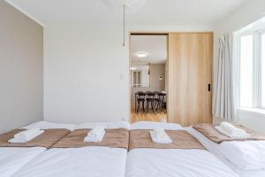 a bedroom with a large bed with two white towels at Ijiri Good Place House in Fukuoka +41 photos