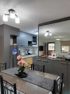 a kitchen with a table with a vase of flowers on it at One Oasis 2BR beside SM City Mall upto 6pax in Davao City