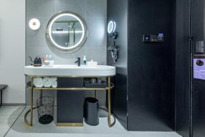 a bathroom with a sink and a mirror at Atour X Hotel, Dongguan Street, Daming Lake,Jinan in Jinan