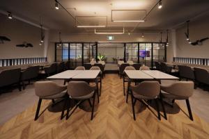 a conference room with tables and chairs in it at Dotombori Crystal Hotel 3 in Osaka