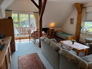 a living room with a couch and a table at Ferienwohnungen Landhaus Stottmert in Herscheid