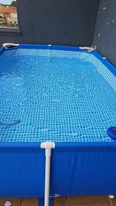a small blue swimming pool in a room at Home RÉSIDENCE OUIDAH in Ouidah