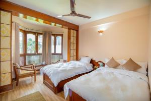 a bedroom with two beds and a window at Laavanya Inn in Pokhara