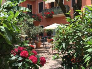 un jardín con flores y plantas frente a un edificio en Residence Gloria, en Montecatini Terme