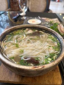 a bowl of noodle soup on a table at Phương Anh 303DM2 in Hanoi