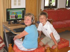 a boy and a girl sitting in front of a computer at Amaryllis Hotel in Karpathos