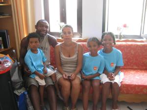 a family sitting on a couch posing for a picture at Amaryllis Hotel in Karpathos