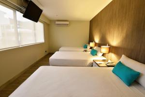 Giường trong phòng chung tại Mariel Hotel Boutique