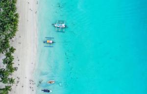 an overhead view of two boats on a beach at La Suerte Villa in Boracay