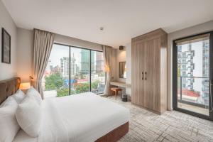 a hotel room with a bed and a large window at Mansion 51 Hotel & Apartment in Phnom Penh