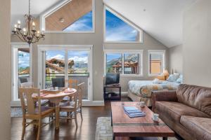 a living room with a couch and a table at Blue Mesa Lodge 40C by AvantStay Ski In Ski Out Unit w Balcony in Telluride