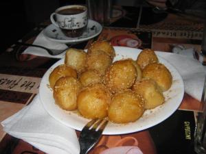 a plate of dumplings on a table with a cup of coffee at Amaryllis Hotel in Karpathos