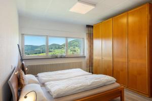 a bedroom with a bed and a window at Ferienhaus Kiliani in Bernau im Schwarzwald