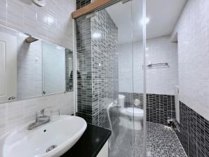a bathroom with a sink and a glass shower at Gold Ocean Apartment Nha Trang in Nha Trang +106 photos