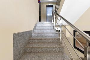 a set of stairs in a building with a hallway at Hotel O Ashoka in Kota