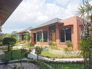 a house in the middle of a garden at Ingsala by CafeAtLuv22 in Ban Bo Rae