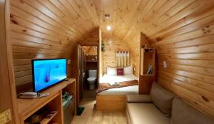 a bedroom with a bed and a tv in a room at MILAN Boutique Garden in Vung Tau