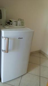 a white refrigerator with two cups on top of it at Guest House Karević in Hvar