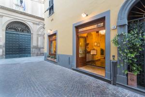 a store front with a door open at Hotel Palazzo Alexander in Lucca