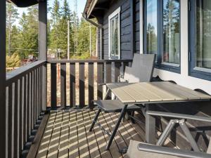 a wooden deck with a table and chair on a house at 6 person holiday home in Kopparberg in Kopparberg