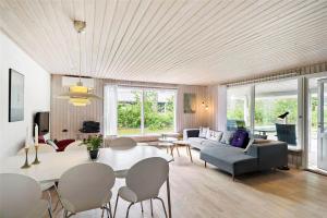 a living room with a table and a couch at 8007-Knebel-Soren-Jeppesens-Vej-5 in Knebel