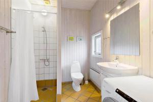 a bathroom with a toilet and a sink and a shower at 8124-Ronde-Rytterparken-33 in Rønde +17 photos