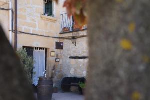 a stone building with a fireplace in a courtyard at Carpe Diem in Navaridas
