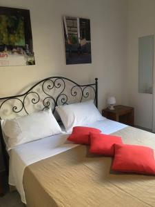 a bedroom with a large bed with a red cross on it at Apartment Co in Palermo