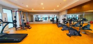 a gym with a row of treadmills and ellipticals at Stena Stays in Kaybagal +12 photos