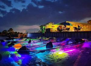 a group of boats on the water at night at Escape by Beaches & Blue Angels in Pensacola