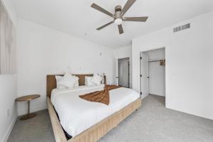 a bedroom with a bed with a ceiling fan at Sea Breeze Escape 3BR Coastal Gem with 2 Balconies in Los Angeles +35 photos