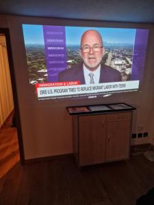 a television screen with a picture of a man on it at Kugelgasse Apartments - Smart Living by Klang und Kleid in St. Gallen