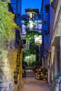 an alley with stairs leading up to a building at Apartments Villa Anka in Komiža