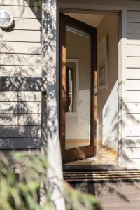 a front door of a house with the door open at The Willows Coastal Retreat in Old Ocean Grove in Ocean Grove