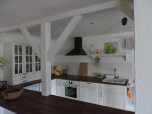 a kitchen with white cabinets and a sink at Reitanlage Duffner in Horst